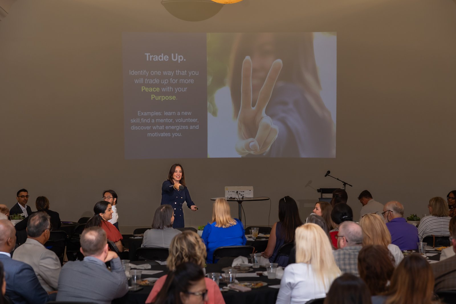 Linnea Miller speaking to an audience at a keynote